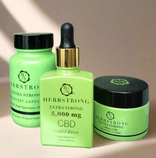 herbstrong capsules, gold recovery drops and cream under soft light